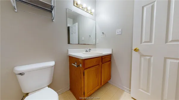 a bathroom with a toilet sink and mirror