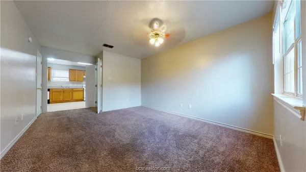 a view of an empty room with a window