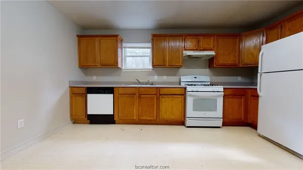 a kitchen with white cabinets and white appliances