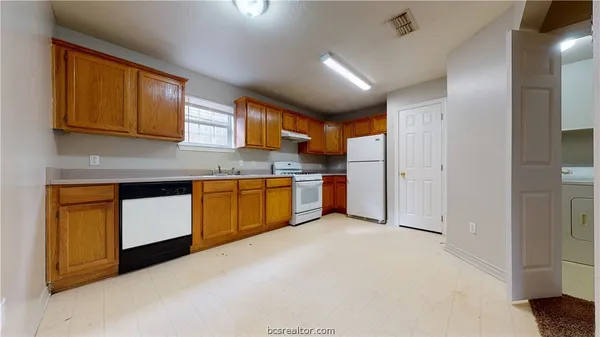 a kitchen with stainless steel appliances granite countertop a stove sink and cabinets