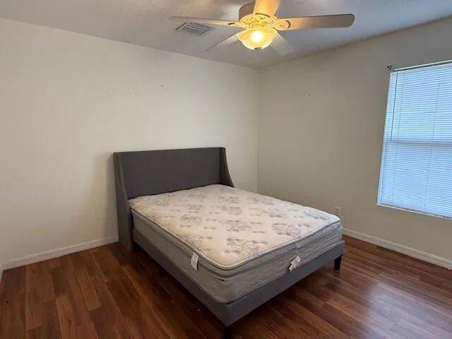 a bed sitting in a bedroom next to a window