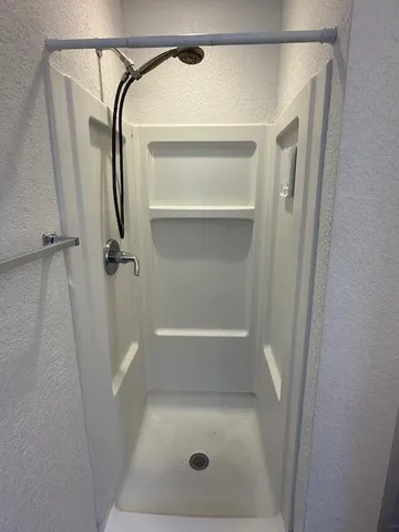 a bathroom with a glass shower door