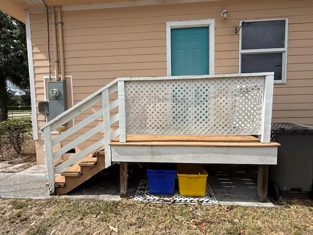 a front view of a house with wooden stairs