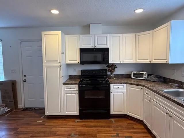 a kitchen with a stove and a microwave