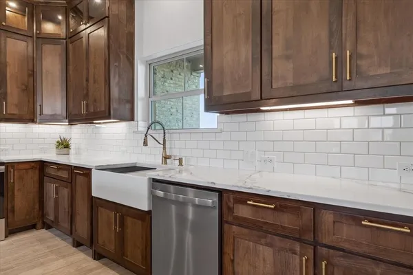 a kitchen with a sink stove and cabinets