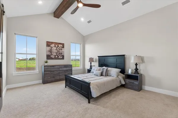 an empty room with windows and ceiling fan
