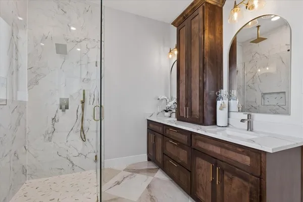 a bathroom with a sink a toilet and shower