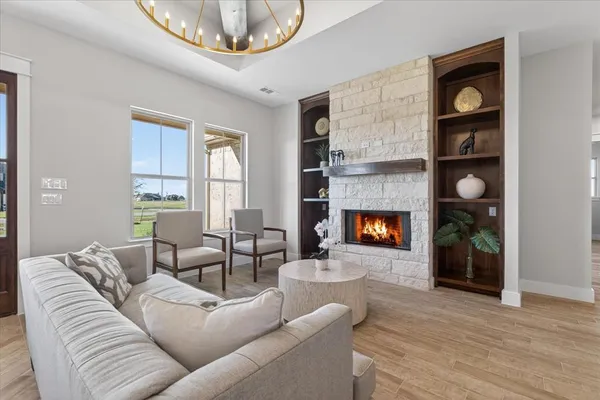 a living room with furniture and a chandelier