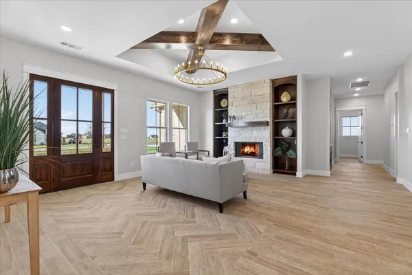 a living room with fireplace furniture and a wooden floor