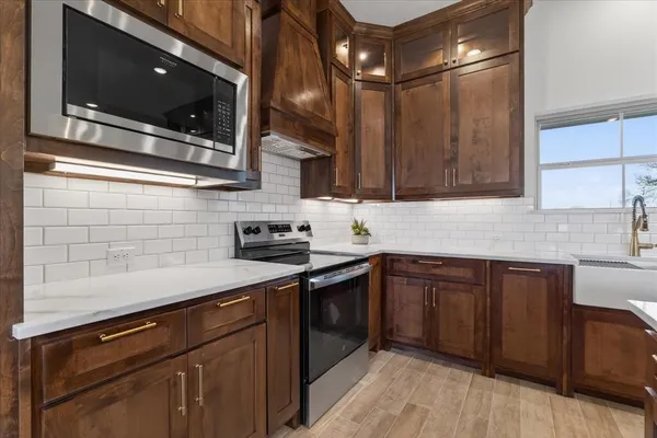 a kitchen with a sink cabinets and stainless steel appliances