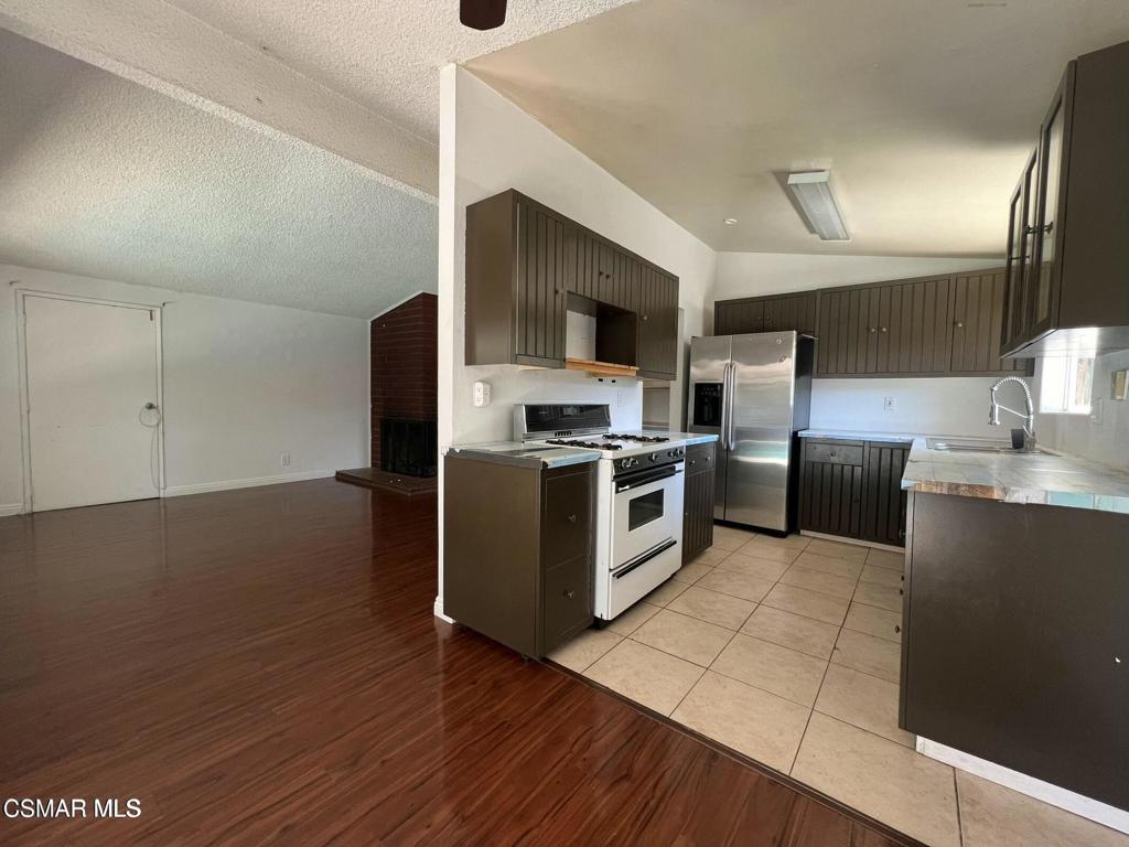 1507 4th Street Simi Valley, CA 93065 - Photo 11 of 16 a kitchen with stainless steel appliances granite countertop a stove a sink and a refrigerator