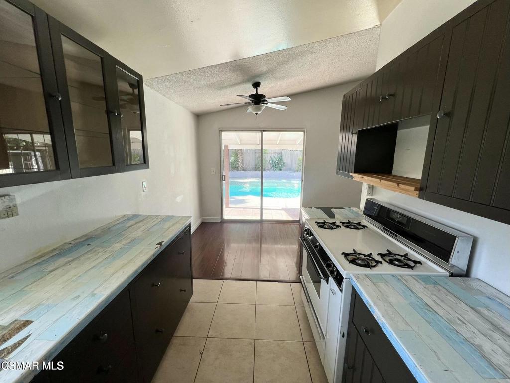 1507 4th Street Simi Valley, CA 93065 - Photo 10 of 16 a kitchen with a stove and a flat screen tv