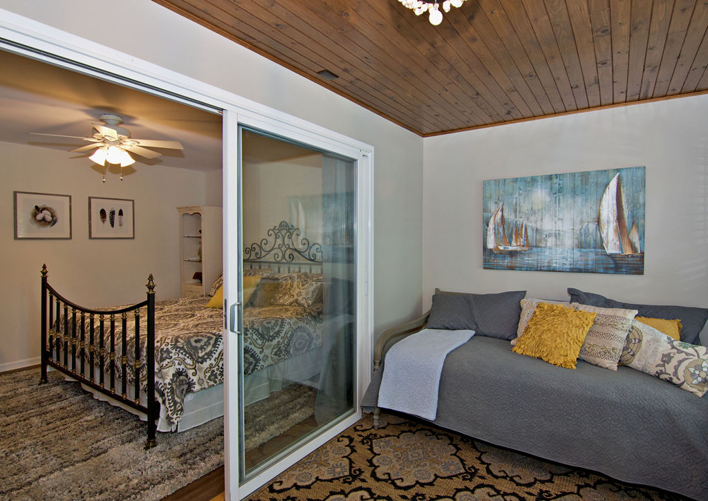 11001 Lake Ridge Lane Seneca, SC 29672 - Photo 35 of 50 Rich wood plank ceilings and sliding doors distinguish this versatile bedroom.
