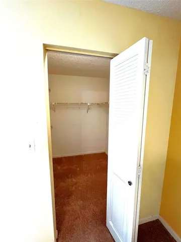 a spacious bathroom with a shower sink mirror and toilet
