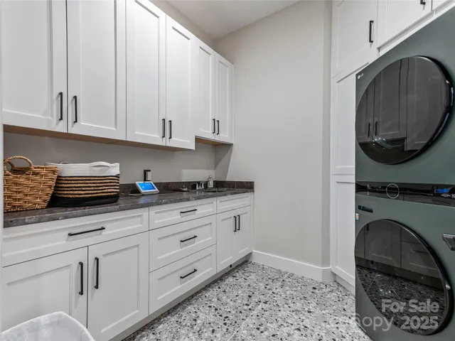 a kitchen with granite countertop a sink a stove and a stove