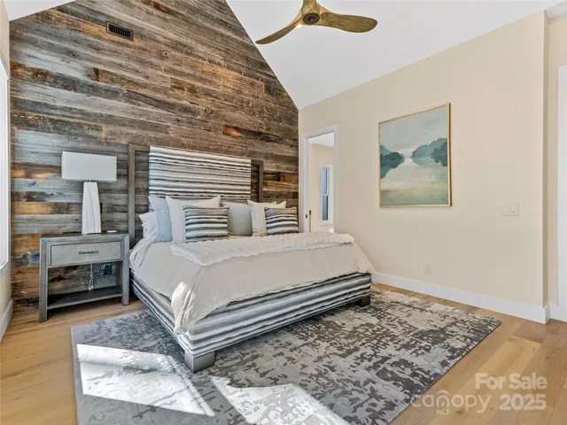 a bedroom with a bed and balcony view