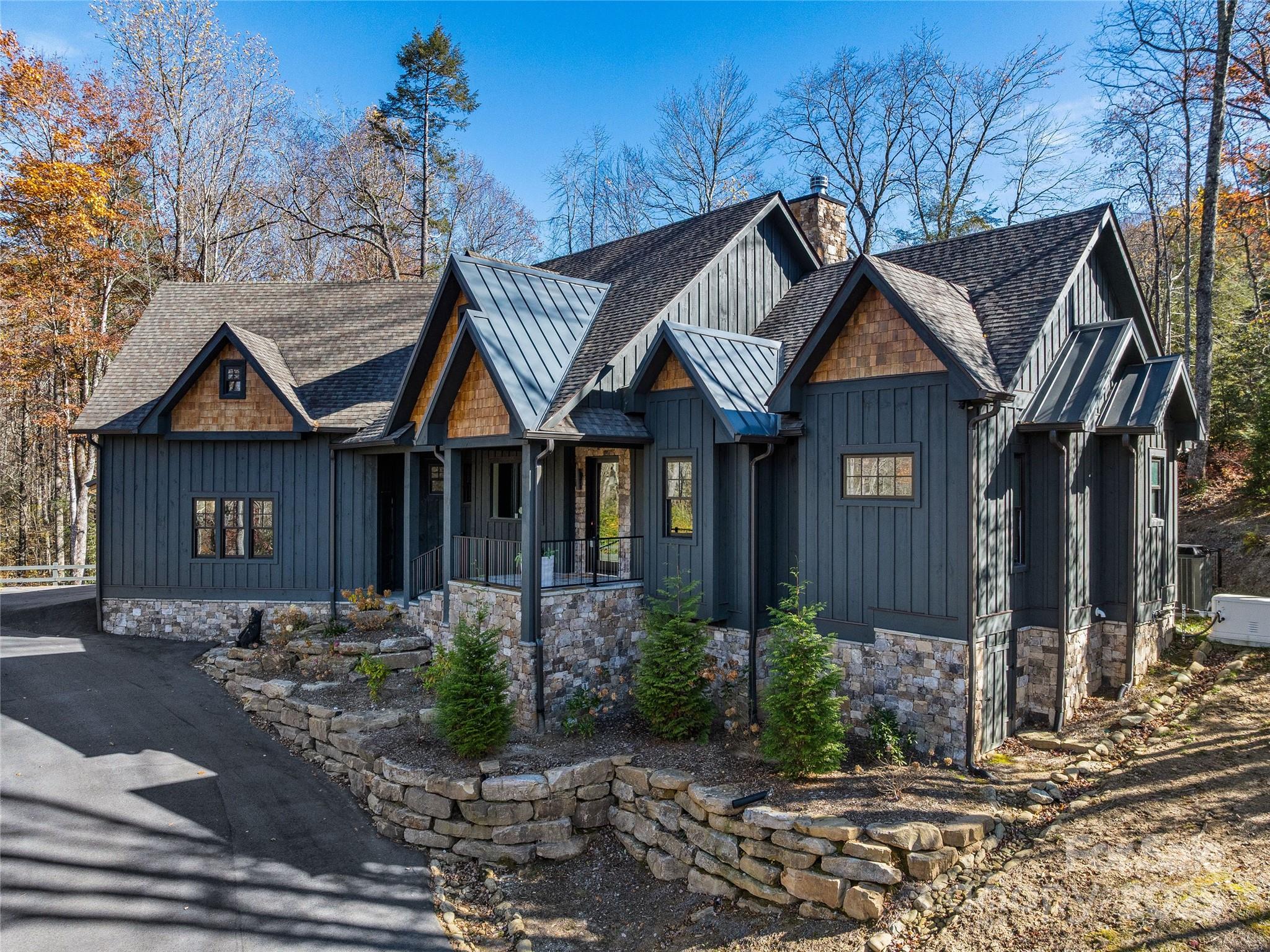 374 Turkey Roost Road Sapphire, NC 28774 - Photo 2 of 39 a front view of a house with garden