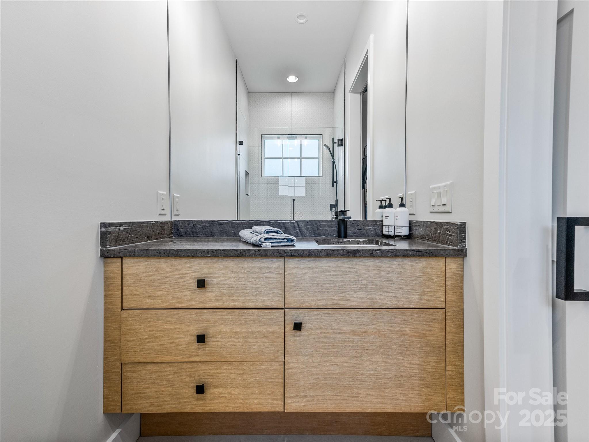 374 Turkey Roost Road Sapphire, NC 28774 - Photo 25 of 39 a bathroom with a sink and a mirror