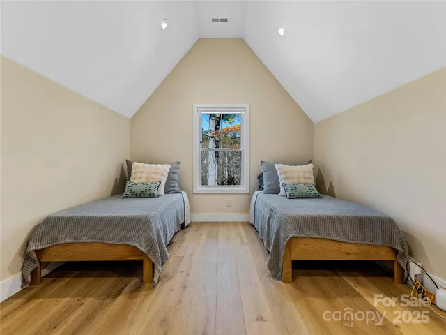 a bedroom with a bed and a night stand