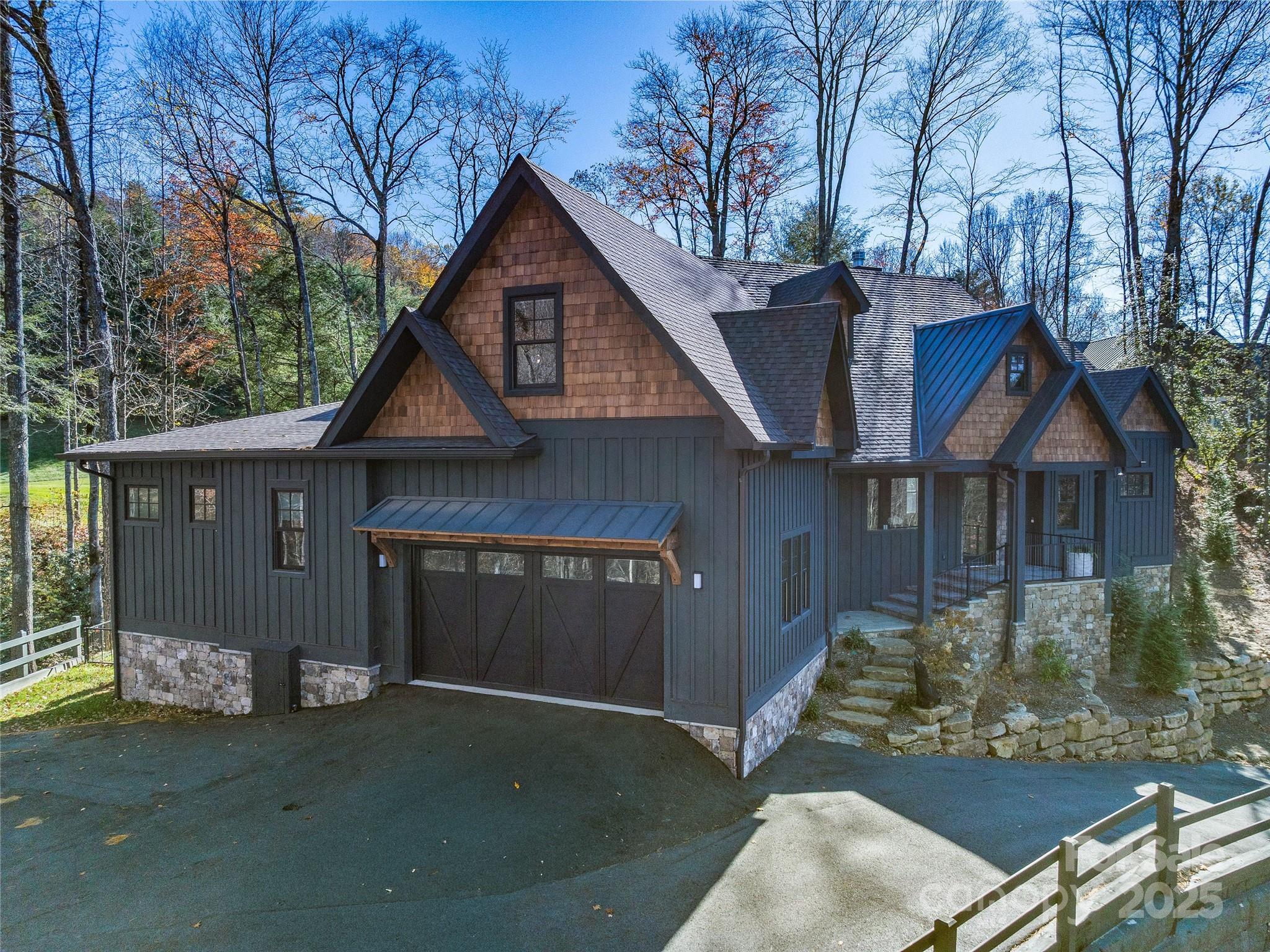 374 Turkey Roost Road Sapphire, NC 28774 - Photo 36 of 39 a front view of a house with a yard and garage