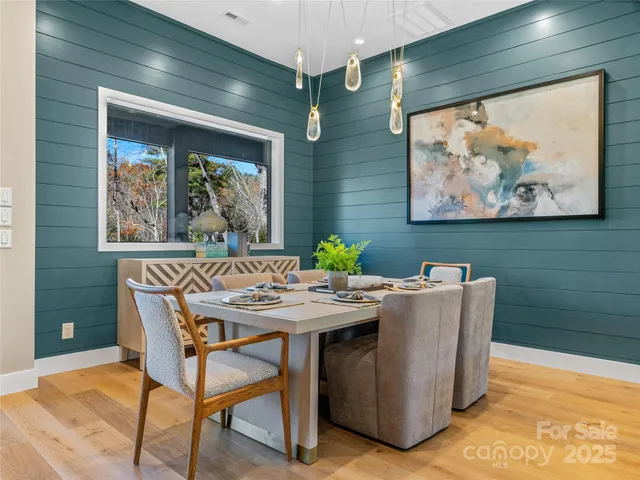a view of a dining room with furniture large window and wooden floor