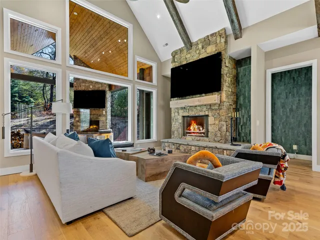 a living room with fireplace furniture flat screen tv and a fireplace
