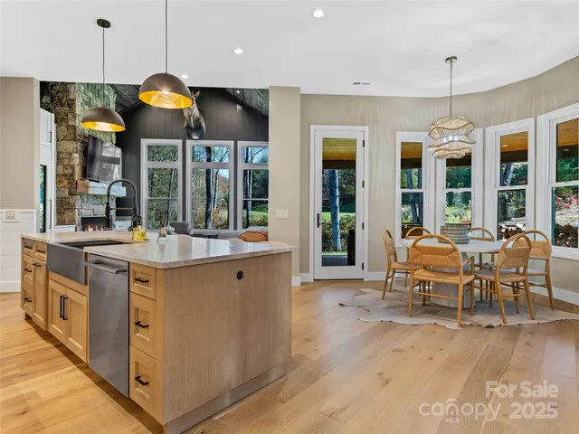 a kitchen with kitchen island granite countertop a sink and a stove