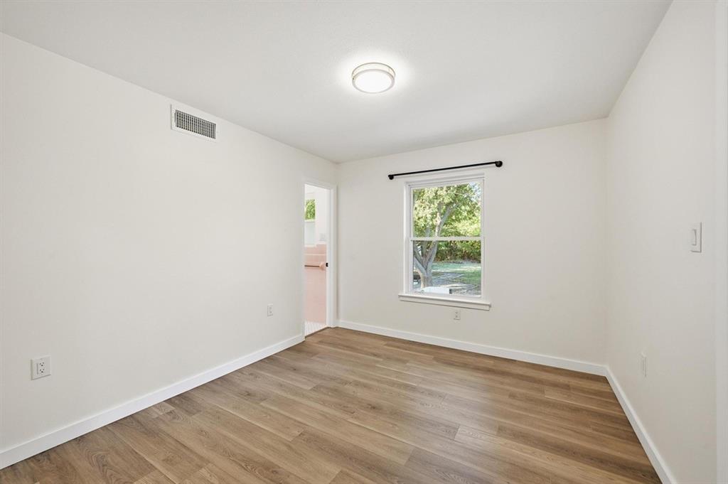 450 Kelly Lane Van Alstyne, TX 75495 - Photo 10 of 16 wooden floor in an empty room with a window