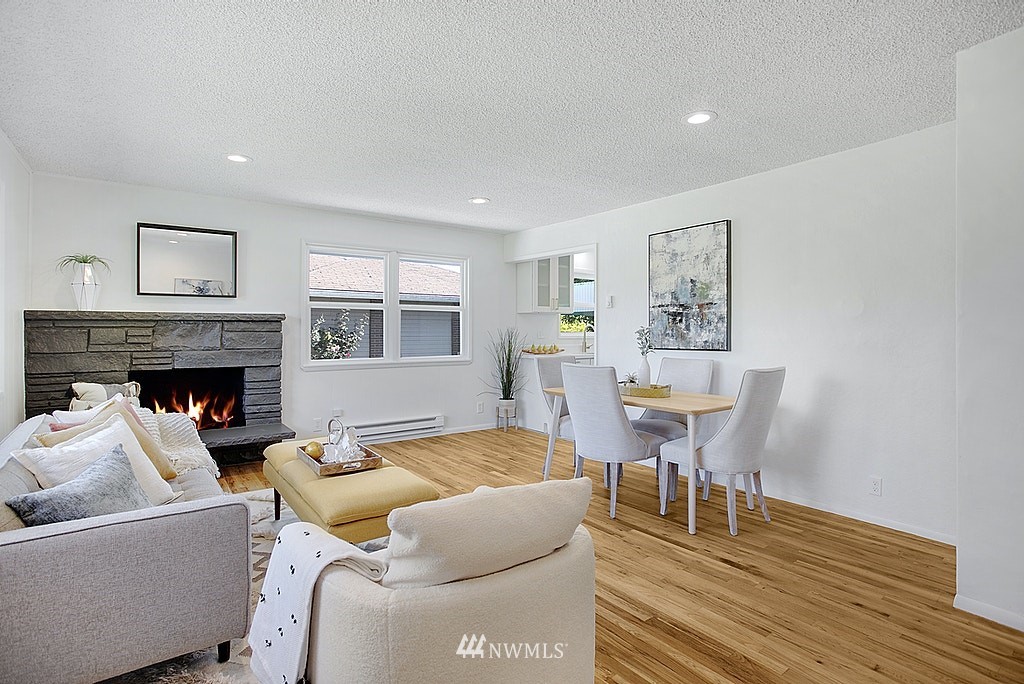 9226 13th Avenue Southwest Seattle, WA 98106 - Photo 2 of 13 a living room with furniture a fireplace and a table