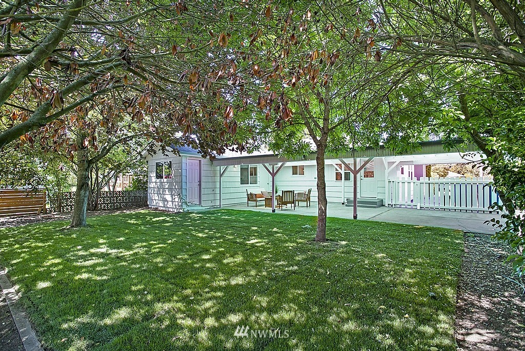 9226 13th Avenue Southwest Seattle, WA 98106 - Photo 12 of 13 a garden with trees in front of it