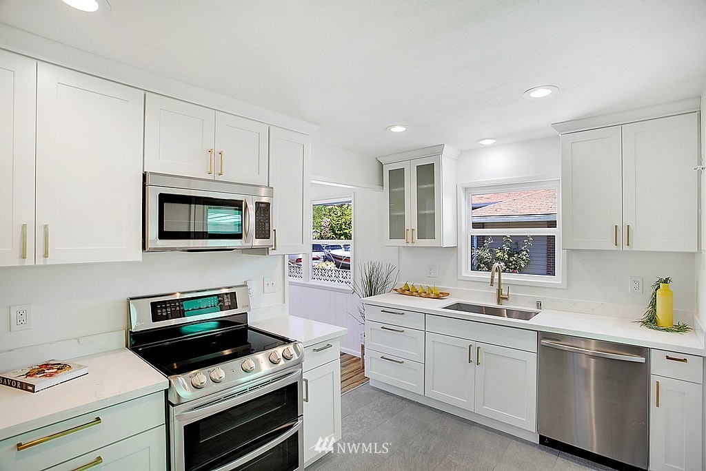 9226 13th Avenue Southwest Seattle, WA 98106 - Photo 4 of 13 a kitchen with a sink stove and microwave