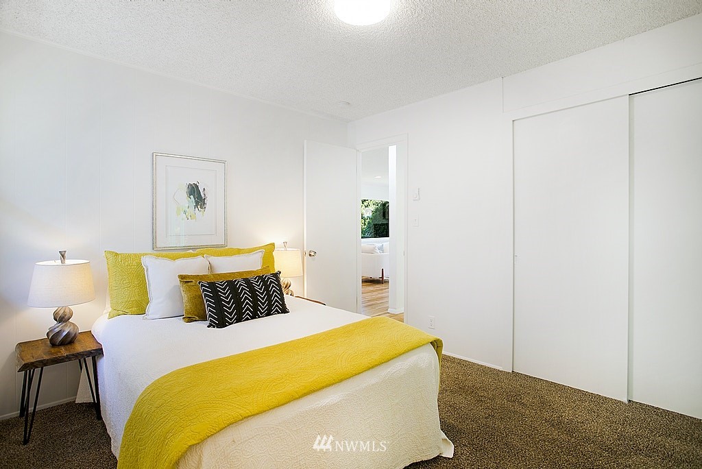 9226 13th Avenue Southwest Seattle, WA 98106 - Photo 6 of 13 a bedroom with a bed and wooden floor