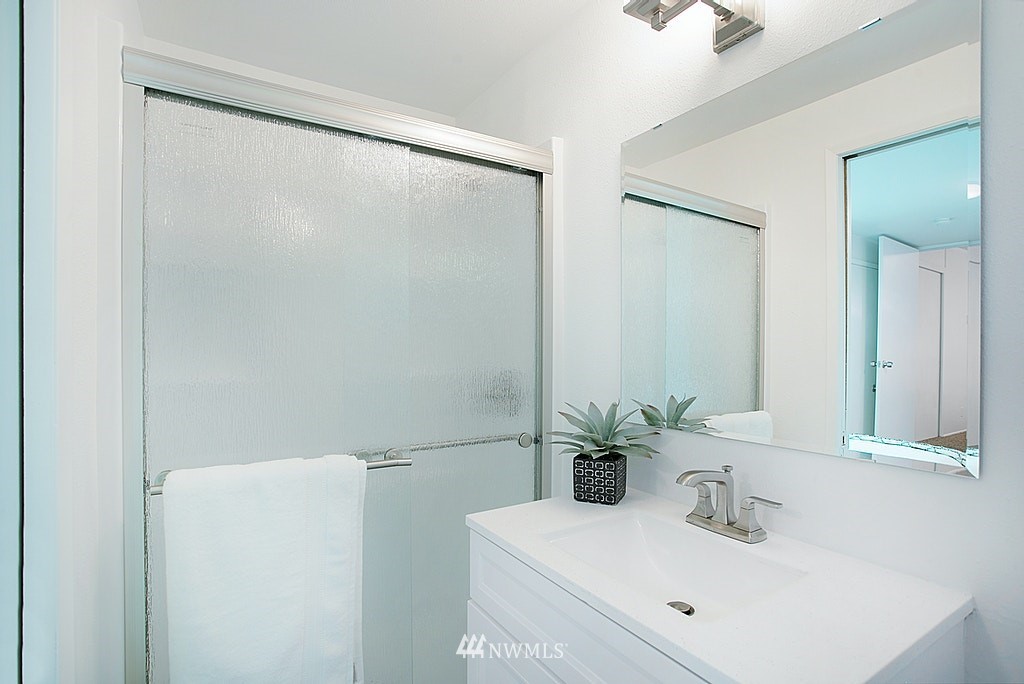 9226 13th Avenue Southwest Seattle, WA 98106 - Photo 10 of 13 a bathroom with a sink and a mirror