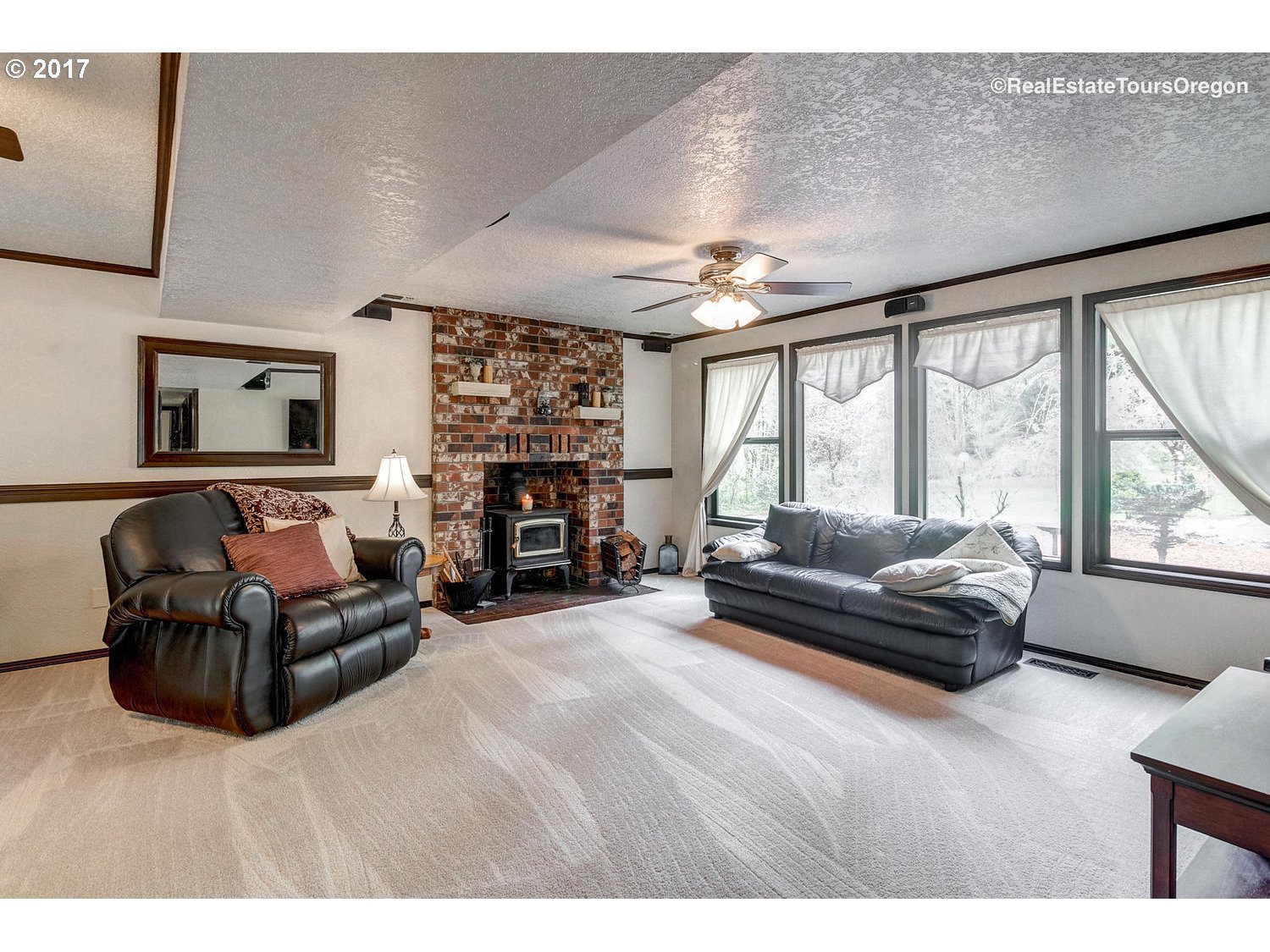 40940 Southeast Kubitz Road Sandy, OR 97055 - Photo 26 of 32 a living room with furniture a large window and a fireplace