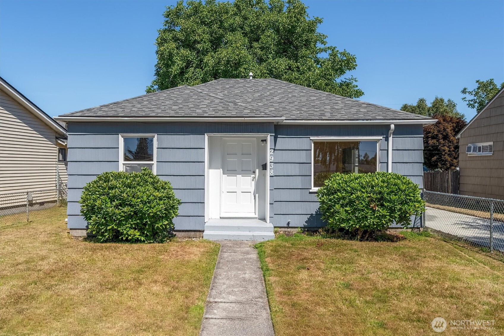 front view of a house with potted plants