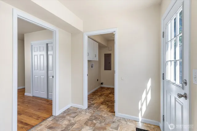 a view of a hallway with wooden floor and entryway