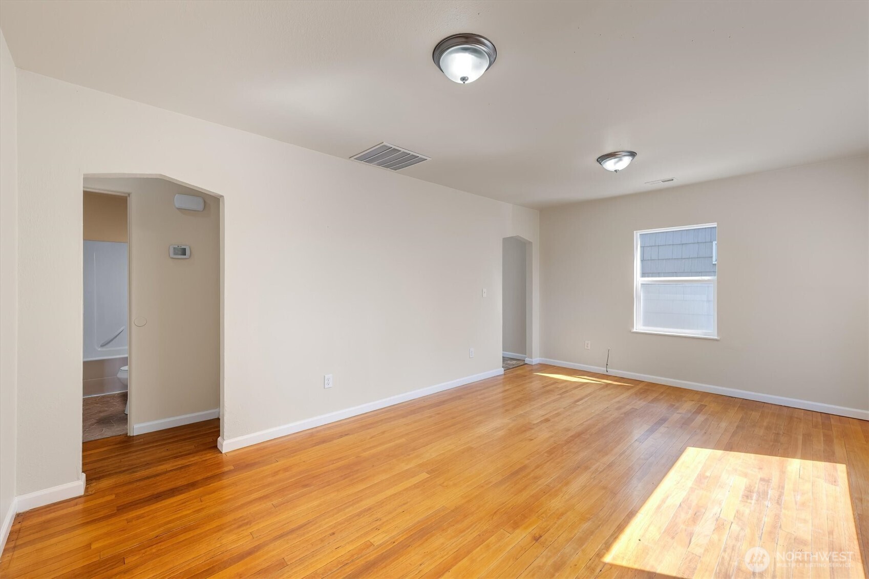 2938 Washington Way Longview, WA 98632 - Photo 5 of 21 an empty room with wooden floor and windows