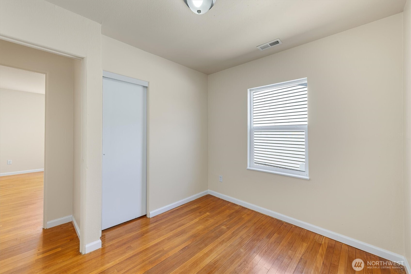 2938 Washington Way Longview, WA 98632 - Photo 7 of 21 a view of an empty room with wooden floor and a window