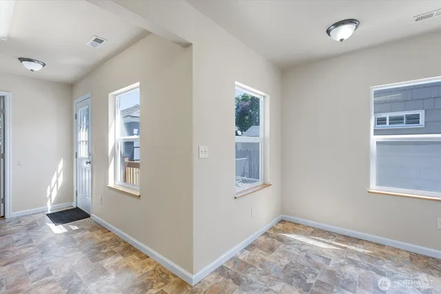 an empty room with windows and closet