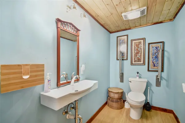 a bathroom with a toilet a sink and mirror