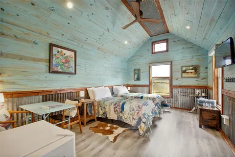 a bedroom with furniture and a window