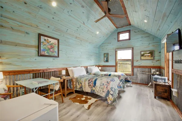 a bedroom with furniture and a window