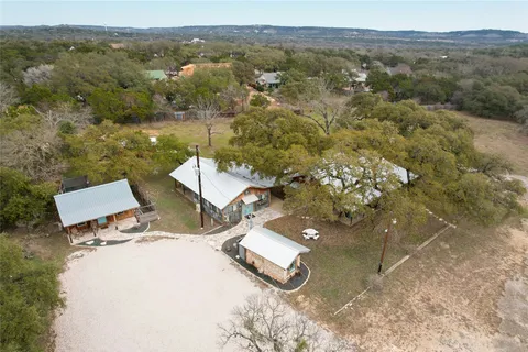 an aerial view of a house with a yard basket ball court