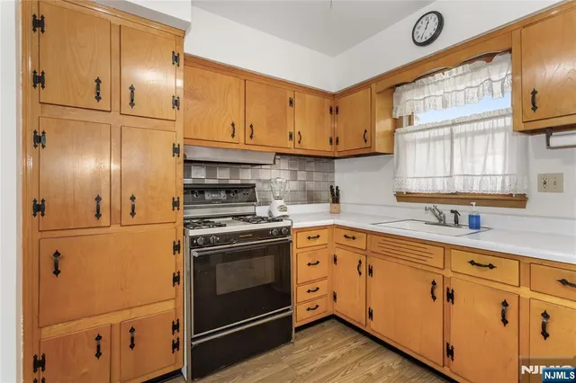 a bathroom with a sink a toilet a mirror and shower