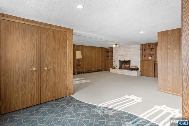 a view of an empty room with a fireplace and a window
