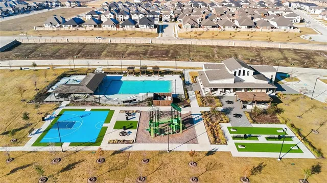 an aerial view of a building with streets and trees