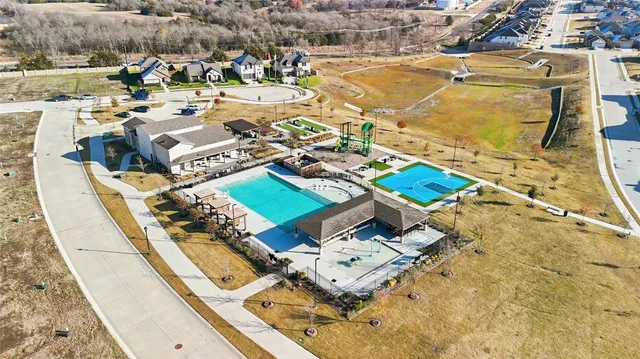 an aerial view of residential houses with outdoor space
