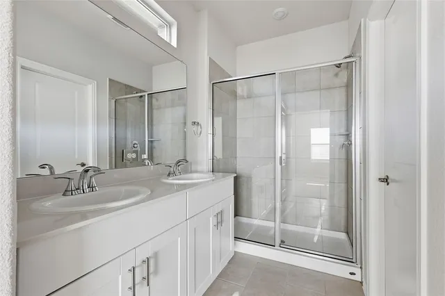 a bathroom with a double vanity sink and mirror