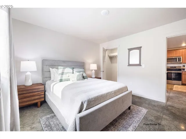 a bedroom with a bed and a night stand