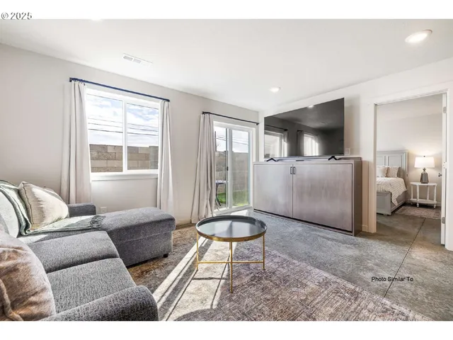 a living room with furniture and a window